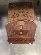 A 19th C. IRON TRIVET TOGETHER WITH AN 1897 CARVED OAK PIPE RACK