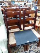 A SET OF FOUR 20th C. OAK LADDER BACK CHAIRS WITH RUSH SEATS ABOVE SQUARE SECTIONED LEGS