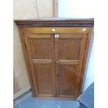 A GEORGE III OAK CORNER CUPBOARD, EACH DOOR OF TWO PANELS. W 78 x H 107cms.