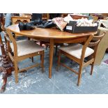 A 1970S TEAK EXTENDING DINING TABLE TOGETHER WITH FOUR CHAIRS, THE TABLE EXTENDED. W 161 x D 122 x H