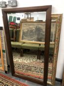 A LARGE BEVEL EDGED MIRROR WITH FLORAL FRAME H 130 x W 102 TOGETHER WITH A HARDWOOD FRAMED EXAMPLE.