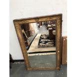 A RECTANGULAR MIRROR IN A 19th C. GILT FRAME, THE CAVETTO WITH ANTHEMION CORNERS AND CENTRAL