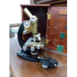 A COOKE, TROUGHTON AND SIMMS MICROSCOPE WITH ADJUSTABLE STAGE.