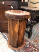 A VICTORIAN MAHOGANY COLUMN FORM LIFT TOP WASH STAND