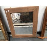 A RECTANGULAR MIRROR IN A PINE FRAME. 69 x 57cms.