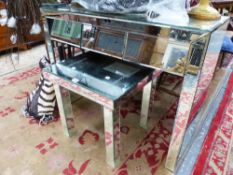 A MIRROR MOUNTED THREE DRAWER DRESSING TABLE WITH A STOOL EN SUITE