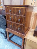 A MODERN LABURNAM OYSTER VENEERED THREE DRAWER CHEST ON STAND. W 47 x D 37 x H 90cms.