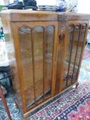 A WALNUT VINTAGE DISPLAY CABINET WITH CARVED DECORATION H 126 x W 102 x D 31 cm's