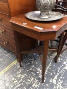 A EDWARDIAN OAK CANTED SQUARE TABLE ON TAPERING SQUARE SECTIONED LEGS JOINED BY STRETCHERS MEETING A