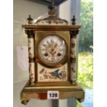 A PORCELAIN AND BRASS CASED JAPY FRERES CLOCK STRIKING ON A COILED ROD, THE COLUMNS, CIRCULAR