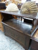 A 20th C. OAK MONKS BENCH WITH THE HINGED TABLE TOP BACK REST ABOVE A COFFER SEAT WITH FOLIATE