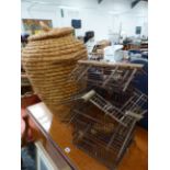 AN ALIBABA STYLE BASKET TOGETHER WITH A VINTAGE WOODEN BIRD CAGE.