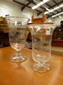 TWO ENGRAVED CLEAR GLASS CELERY VASES OF BELL SHAPE RAISED ON CIRCULAR FEET