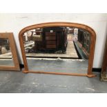 A ROUNDED RECTANGULAR OVERMANTLE MIRROR IN A PINE FRAME. 81.5 x 133cms.