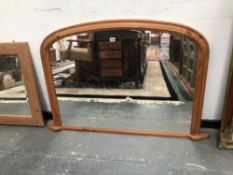 A ROUNDED RECTANGULAR OVERMANTLE MIRROR IN A PINE FRAME. 81.5 x 133cms.