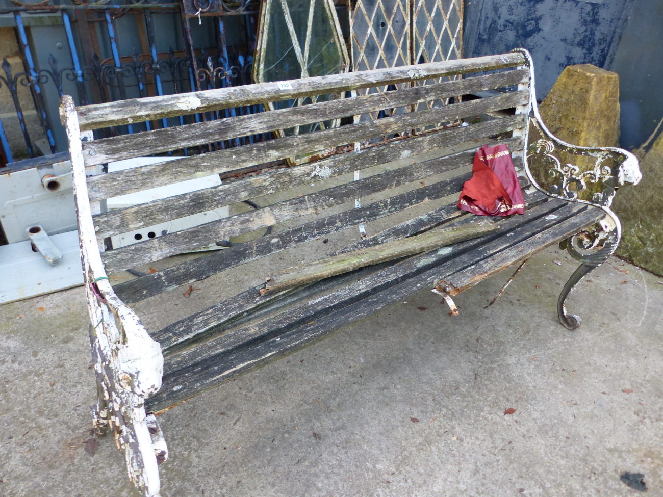 A VINTAGE GARDEN BENCH WITH CAST IRON LION MASKS ENDS