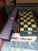 A WOODEN CHESS SET IN A FOLDING BOARD, A CHINESE SCROLL, BOXED PAIR OF BALLS AND A BOXED SET OF
