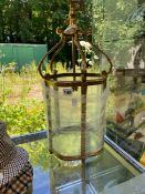 AN BRASS AND CURVED GLASS HANGING HALL LANTERN