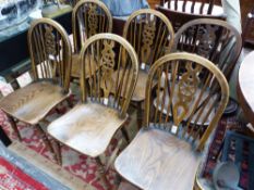 A SET OF SIX OAK SEATED WHEEL BACKED CHAIRS