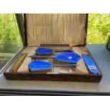 A HALLMARKED SILVER AND ENAMELLED CASED DRESSING TABLE SET