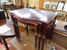 A NEST OF THREE 20th C. MAHOGANY CROSS BANDED SERPENTINE FRONTED COFFEE TABLES