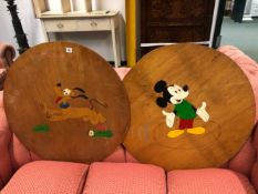 TWO WOODEN TABLE TOP COVERS PAINTED WITH MICKEY MOUSE AND PLUTO DISNEY FIGURES.