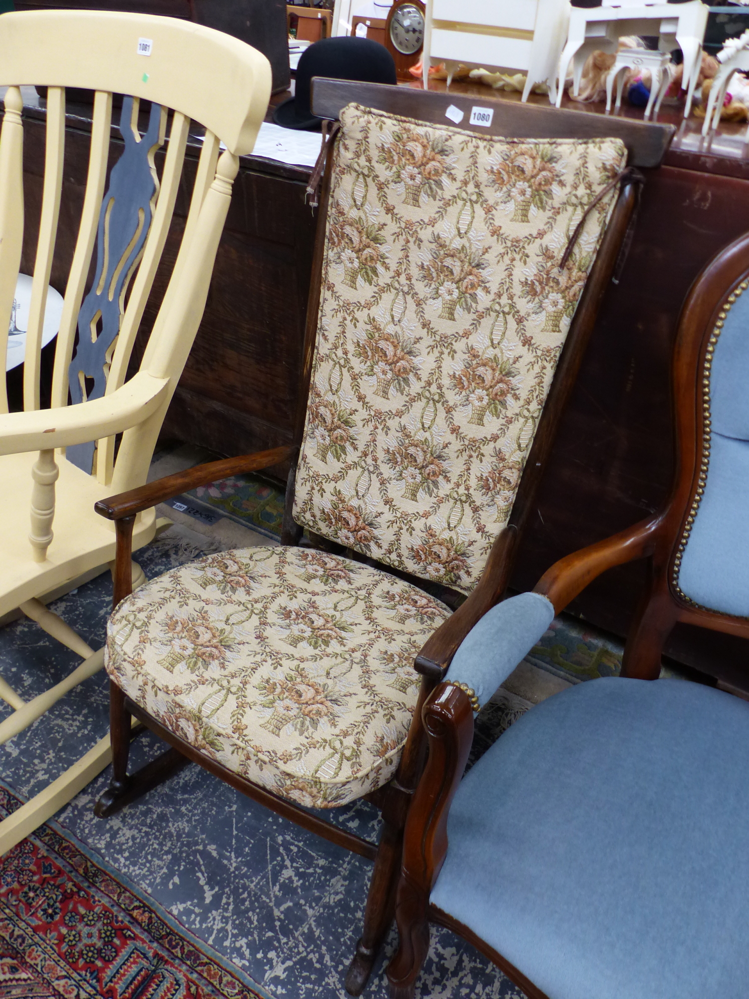 A 20th C. STAINED WOOD ROCKING ARMCHAIR WITH SQUAB CUSHIONED STICK BACK AND DROP IN SEAT