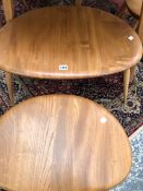 A NEST OF THREE ERCOL BLONDE 'PEBBLE' TABLES