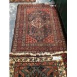 AN ANTIQUE PERSIAN TRIBAL RUG 270 x 112 cm's TOGETHER WITH A SMALL PERSIAN SHIRAZ RUG 143 x 115 cm'