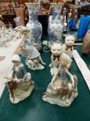 THREE LLADRO FIGURES, A PAIR OF CAT FIGURES AND A PAIR OF TABLE LAMPS.