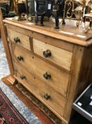 A VICTORIAN PINE FOUR DRAWER CHEST. H 82 W 86 D 42cms TOGETHER WITH A LATER PINE HANGING WALL SHELF