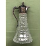 A HALLMARKED SILVER AND CUT GLASS CLARET JUG.