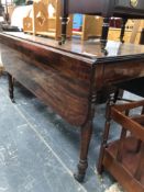 A 19th C. MAHOGANY DROP FLAP TABLE WITH A DRAWER TO ONE END ON TURNED CYLINDRICAL LEGS TAPERING TO