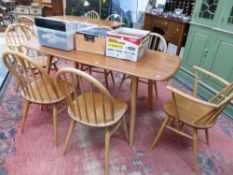 AN ERCOL BLONDE DINING ROOM SET INCLUDES SIX HOOP BACK CHAIRS AND A RECTANGULAR TABLE H 71 W 153 D