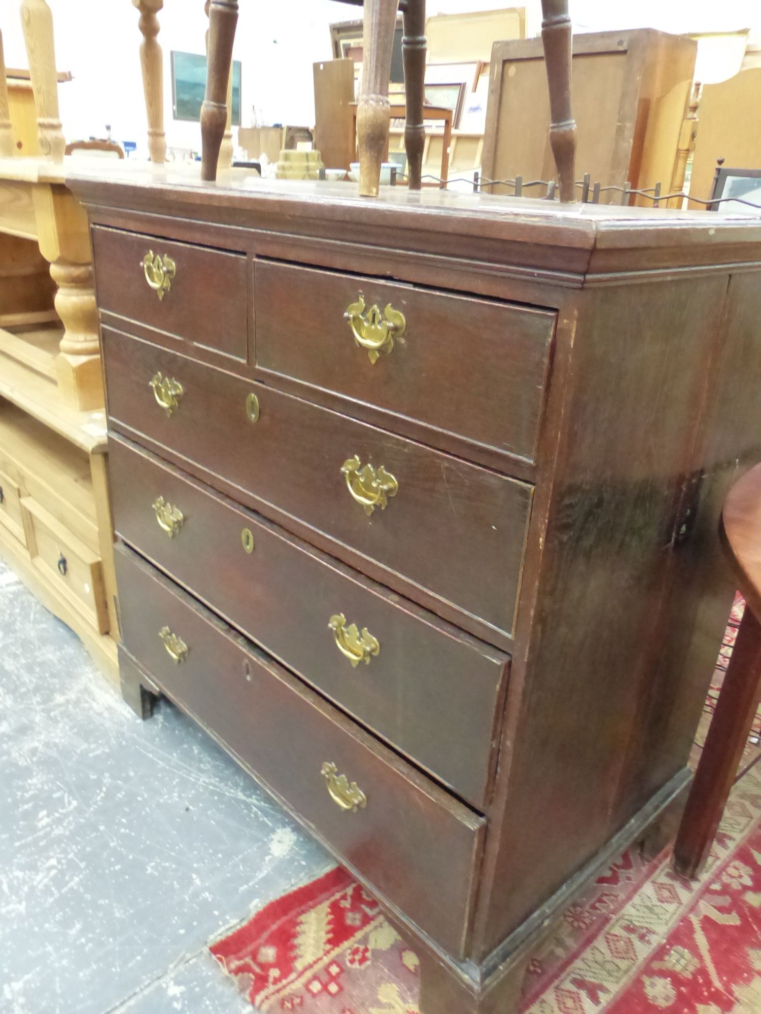 A 19th C. CROSSED BANDED OAK CHEST OF TWO SHORT AND THREE GRADED LONG DRAWERS ON BRACKET FEET. W