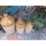 THREE STONEWARE TWO TONE FLAGONS, A GLASS MIXING BOWL AND STIRRER TOGETHER WITH A DEMIJOHN