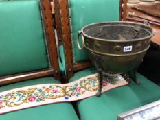 AN ARTS AND CRAFTS BRASS COAL BUCKET AND AN EMBROIDERED BELL PULL.