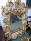 AN ITALIANATE BAROQUE STYLE MIRROR H 146 x W 96 cm's.