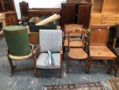 A CARVED OAK GOTHIC REVIVAL HALL CHAIR TOGETHER WITH A GREEN LLOYD LOOM TYPE LAUNDRY BASKET AND