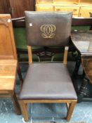 A 20th C. LIMED OAK CHAIR, THE LEATHER BACK WITH A GILT MONOGRAM REPEATED ON THE ACCOMPANYING MESH