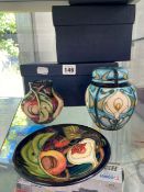 A MOORCROFT LIDDED URN, A VASE AND MATCHING SHALLOW DISH
