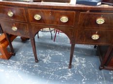 A GEORGE III MAHOGANY BOW FRONT SIDEBOARD, THE CENTRAL DRAWER FLANKED BY TWO ON ONE SIDE AND A