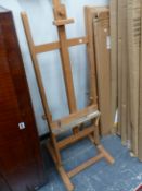 AN ARTISTS EASEL AND A FOLDING TOWEL RAIL