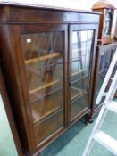 A 1920's OAK LEADED GLASS TWO DOOR BOOKCASE H 143 x W 93 x D 28 cm's