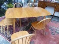 A ERCOL DINING SET TO INCLUDE FOUR HOOP BACK CHAIRS AND AN EXTENDING DINING TABLE (NO LEAF) H 72 W