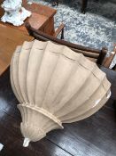 A PLASTER WALL LIGHT, THE EXTERIOR OF THE SHELL SHAPE FLUTED AND PAINTED IN OATMEAL