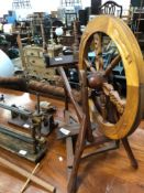 A GROUP OF VINTAGE AND LATER WOOL WINDING ACCESSORIES INCLUDING A SPINNING WHEEL AND A BAG OF WOOL