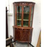 AN EDWARDIAN LINE INLAID MAHOGANY SERPENTINE FRONTED CORNER CUPBOARD, THE UPPER HALF GLAZED AND