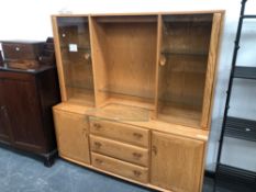 A CONTEMPORARY LONG ELM ERCOL GLAZED CABINET, THREE DRAWER LOWER CABINET SECTION WITH CUPBOARDS, 160