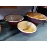 THREE LARGE POTTERY PROVING BOWLS AND A LIDDED FLOUR JAR.